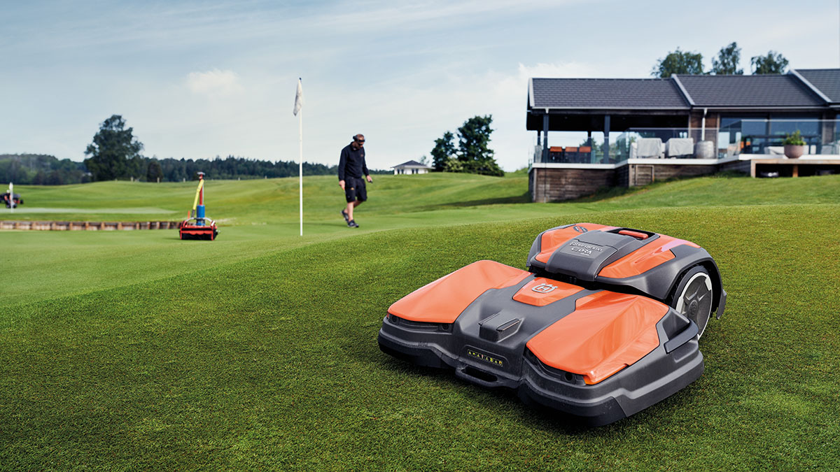 Husqvarna autonomous mower beside a putting green