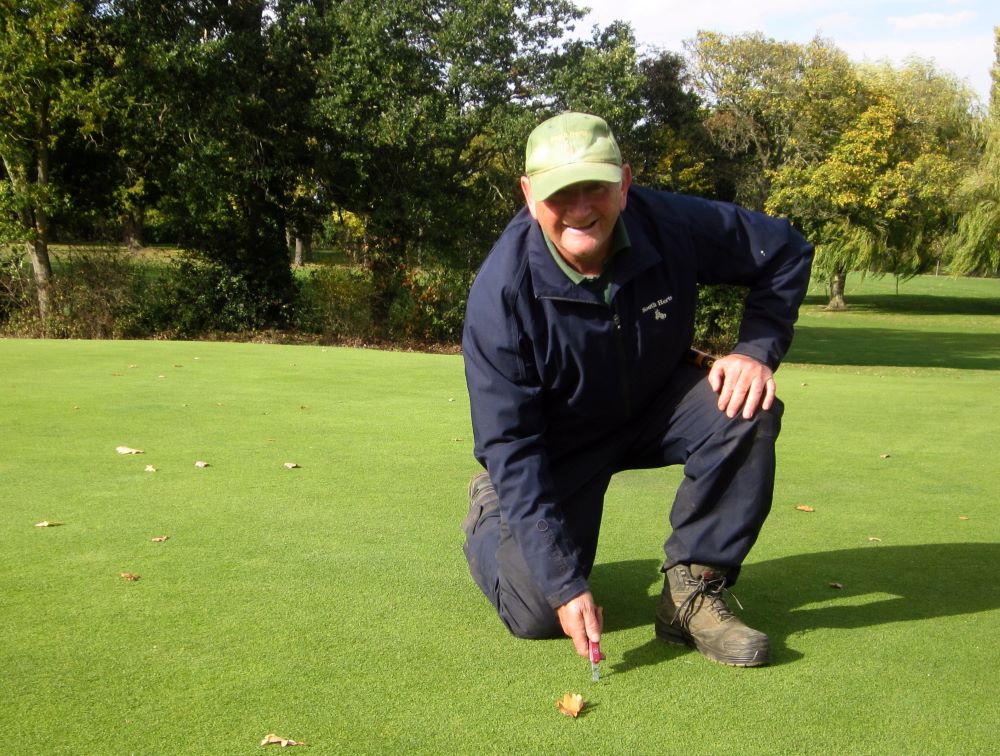 E. John repairing pitch mark.jpg