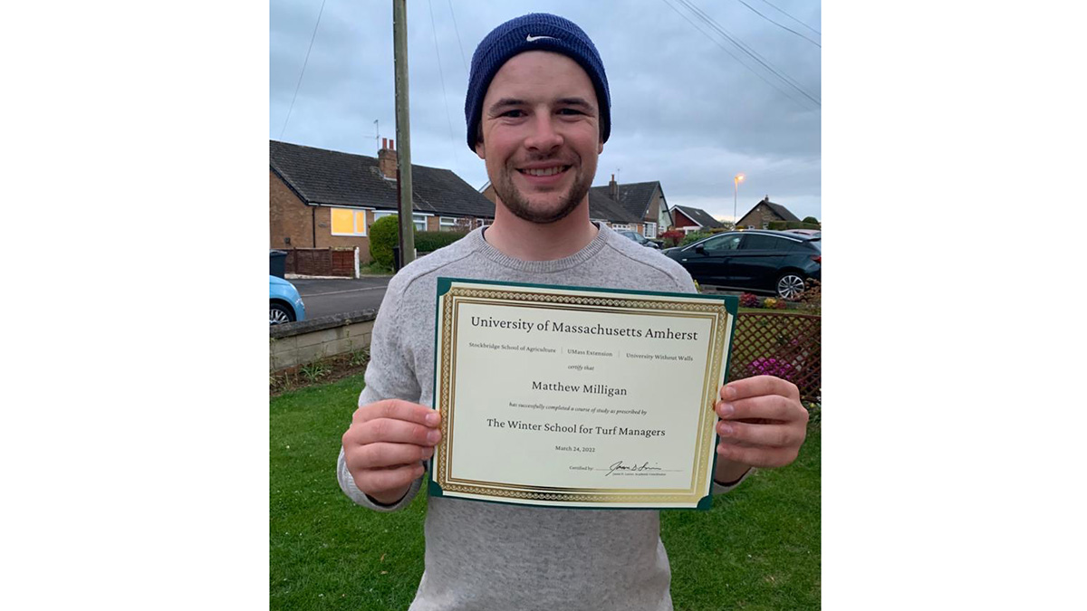 Matt Milligan with his graduation certificate from the University of Massachusetts.jpg 1