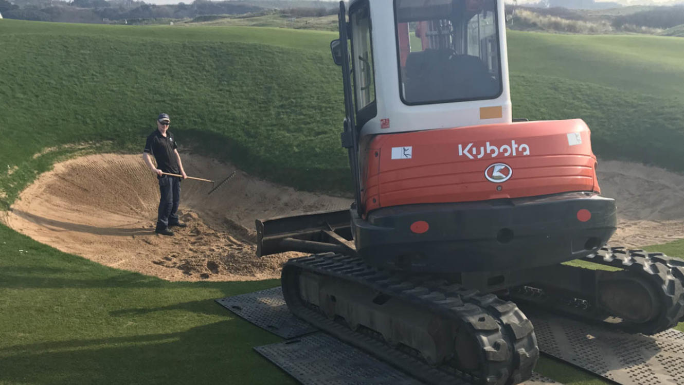 Removing sand from bunkers.jpg