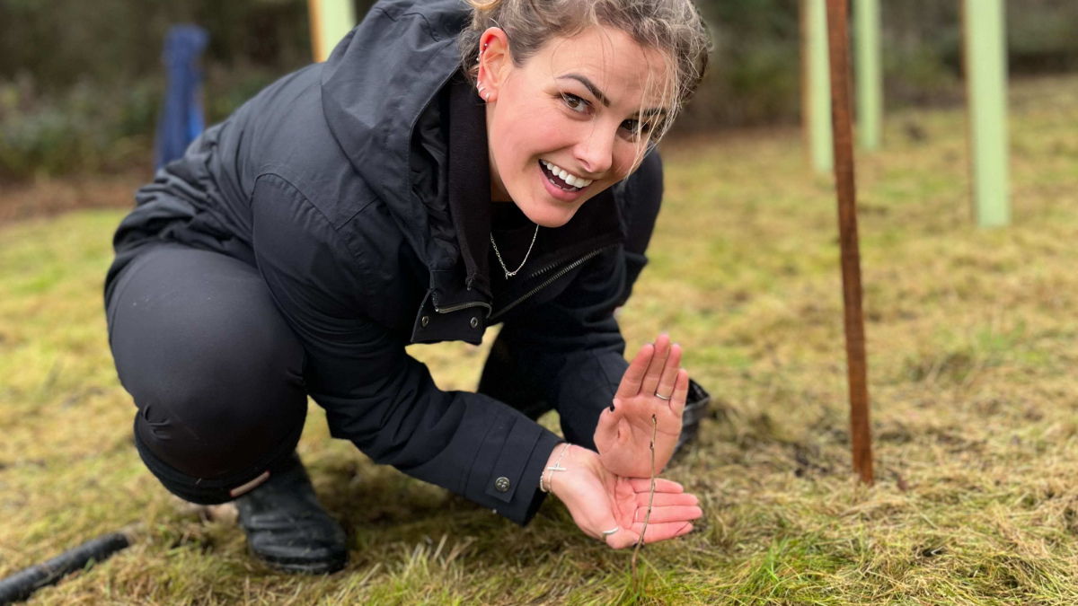 BIGGA's Lauren Frazer proudly displays one of the smaller saplings.jpg