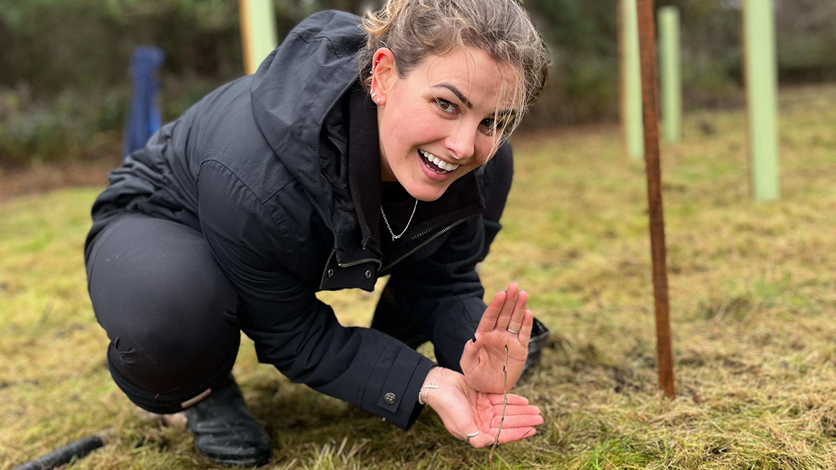 BIGGA's Lauren Frazer proudly displays one of the smaller saplings.jpg 1